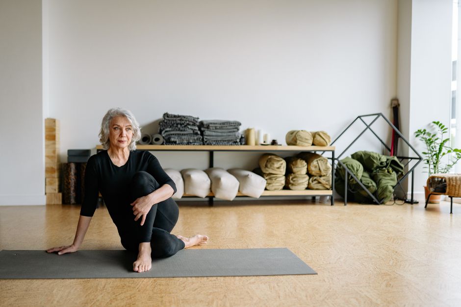 A student fully supported by bolsters in a restorative yoga pose