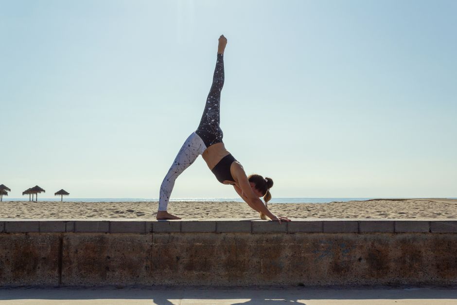 Students flowing through a vinyasa sequence in a sunlit studio